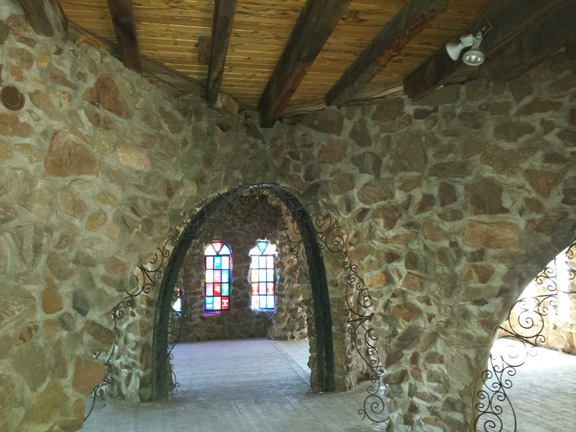 Stone archways on the first floor, supporting the second floor